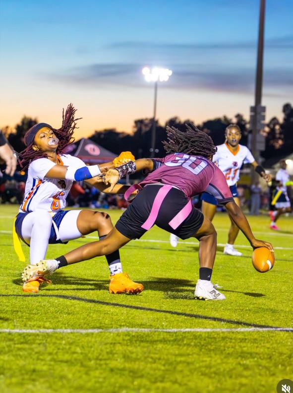 Flag football players competing during a night game